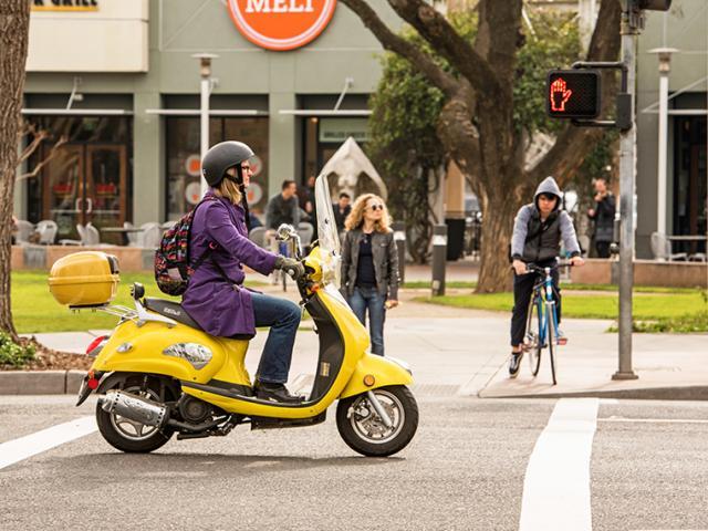 girl riding yellow motorbike 